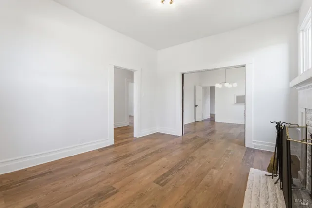 a kitchen with white cabinets and window