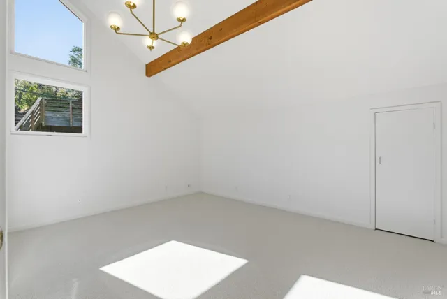 a kitchen with stainless steel appliances a refrigerator a stove and white cabinets