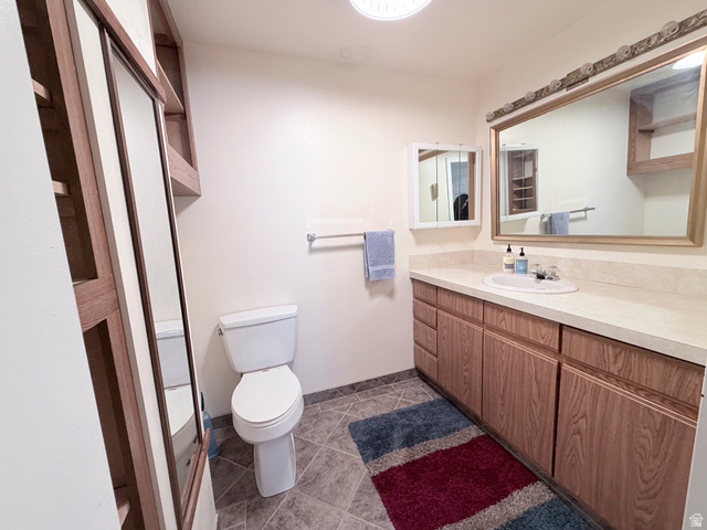 2855 South 1000 West Perry, UT 84302 - Photo 123 of 142 Bathroom featuring vanity and dark tile patterned flooring