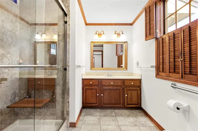 a bathroom with a sink a mirror and a shower