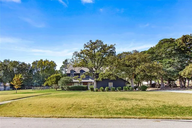 a yellow house with trees in front of it