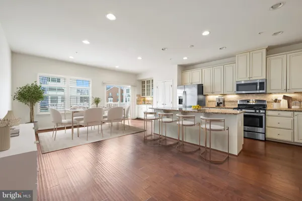 a kitchen with counter top space a sink appliances and cabinets