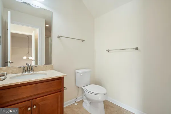 a bathroom with a toilet a sink a mirror and a shower