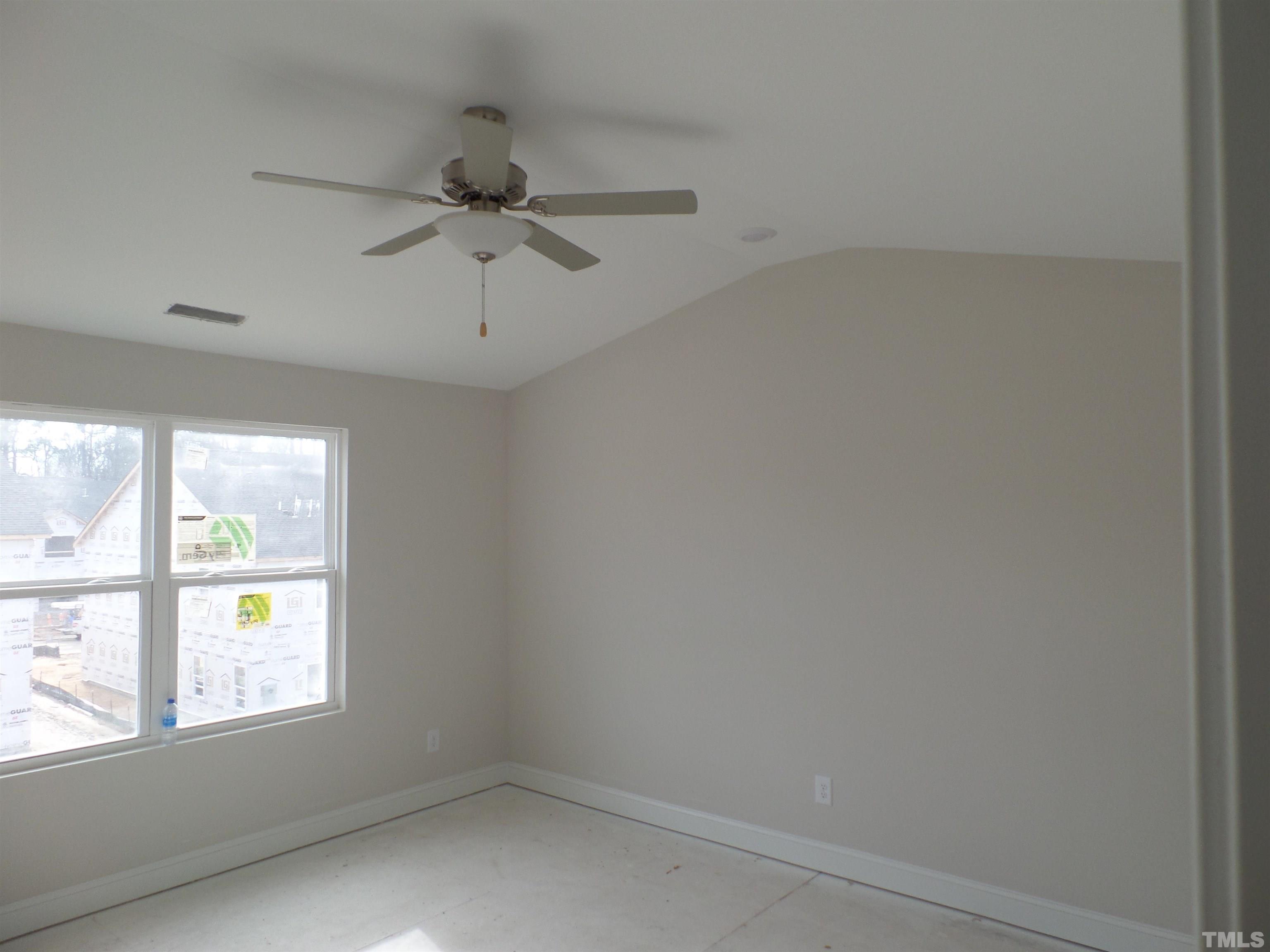 6912 Point Bar Place Raleigh, NC 27616 - Photo 13 of 26 an empty room with a window and a ceiling fan