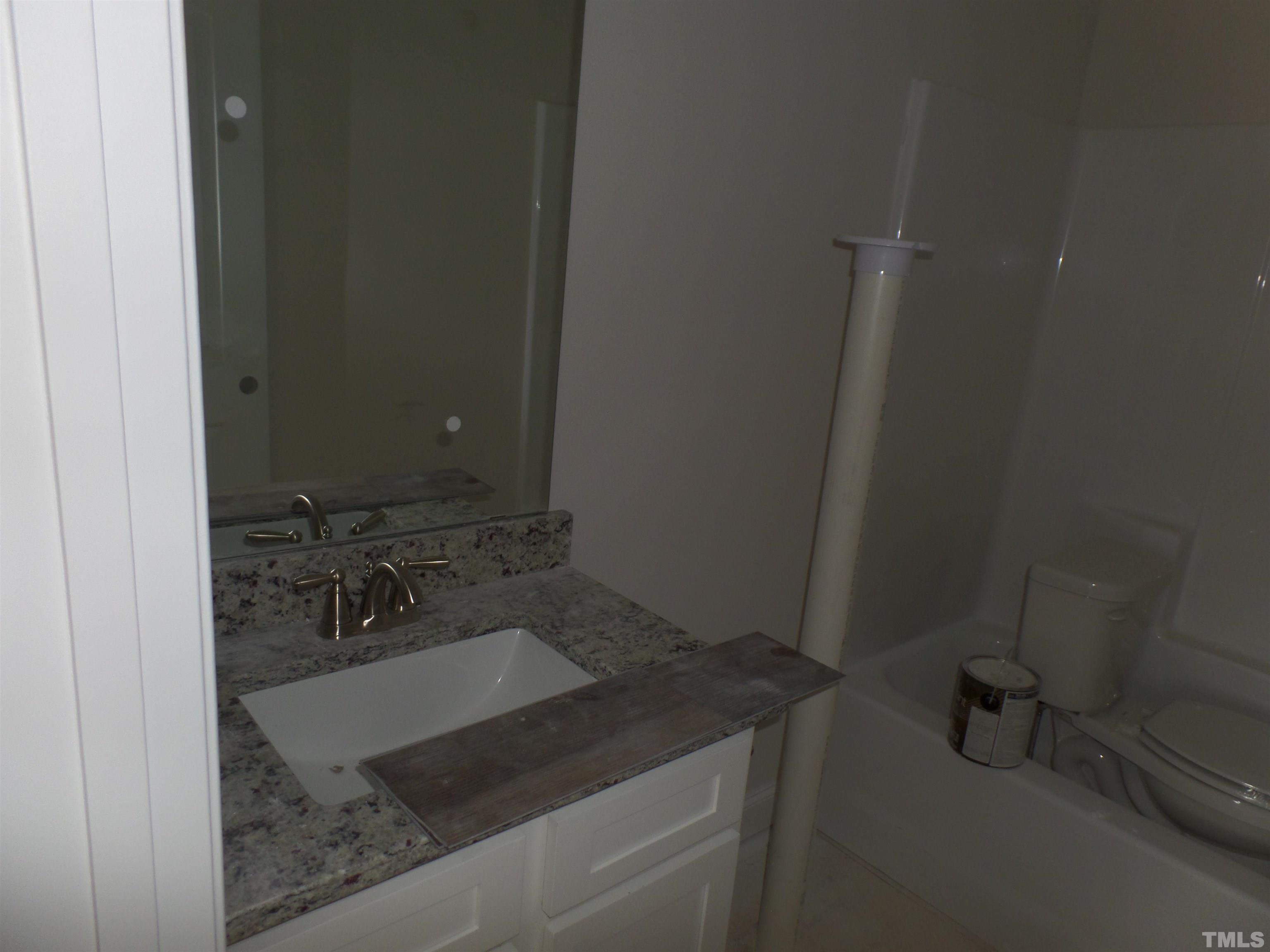 6912 Point Bar Place Raleigh, NC 27616 - Photo 18 of 26 a bathroom with a sink and mirror