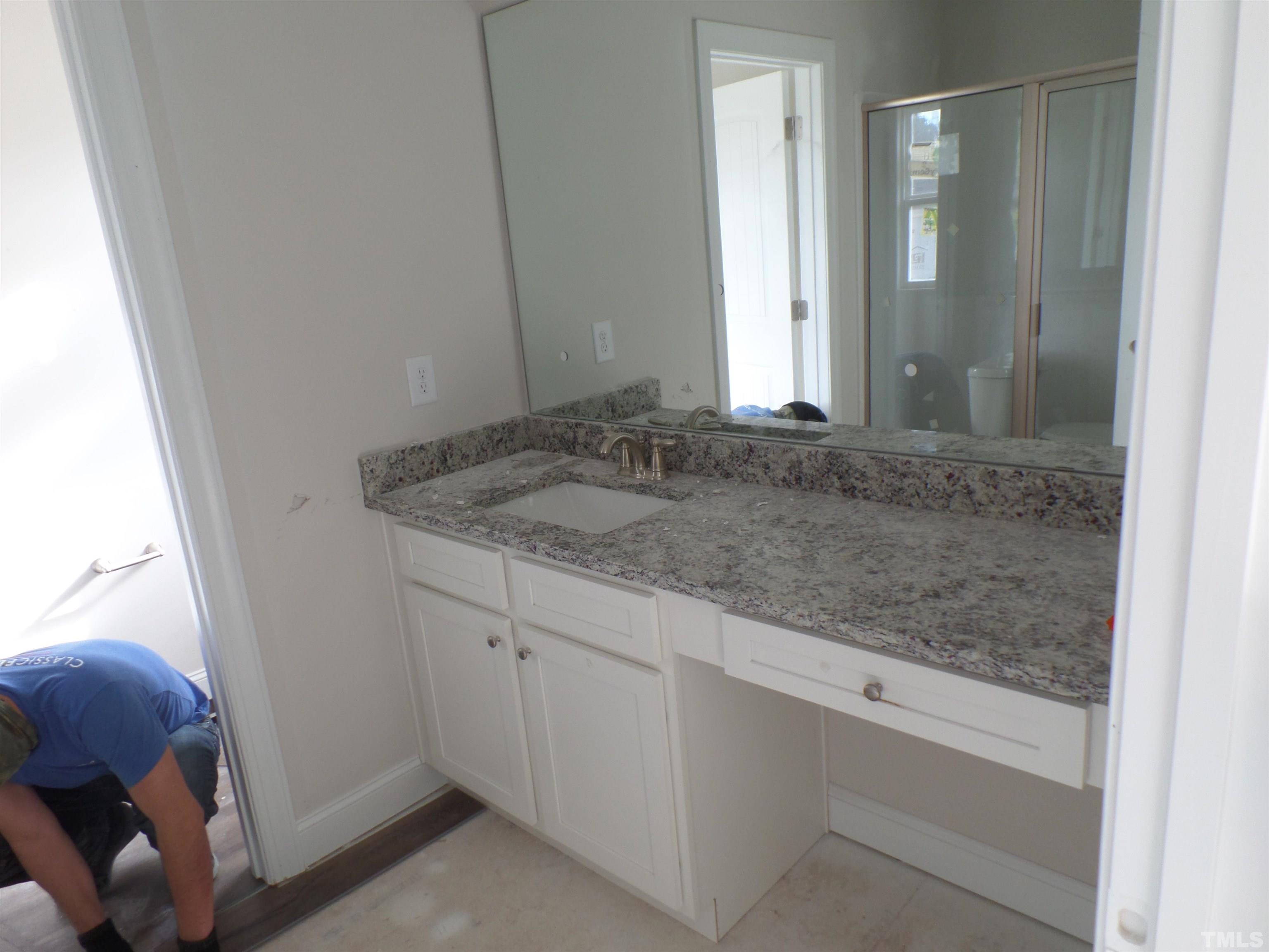 6912 Point Bar Place Raleigh, NC 27616 - Photo 19 of 26 a bathroom with a granite countertop sink and vanity