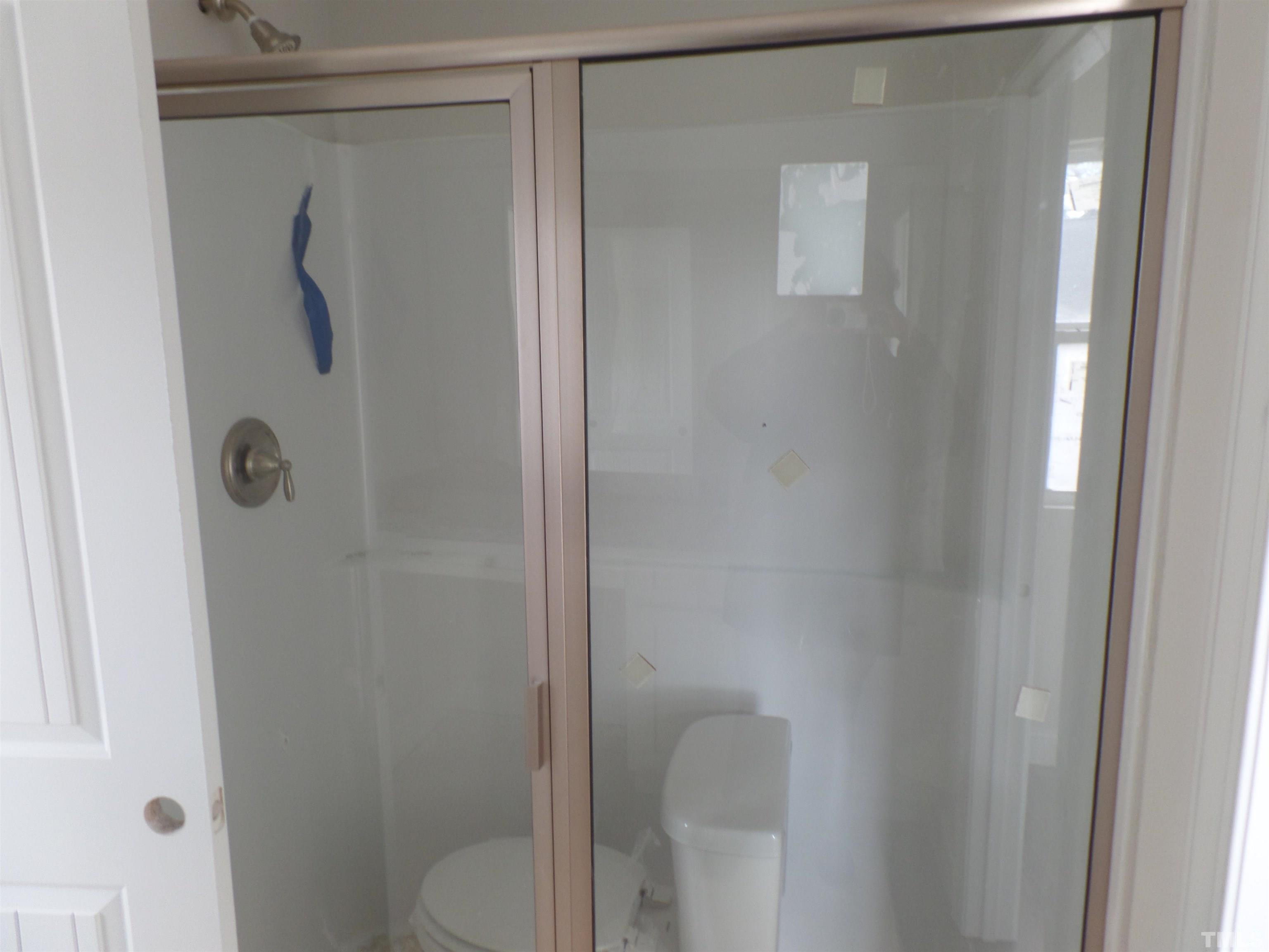 6912 Point Bar Place Raleigh, NC 27616 - Photo 21 of 26 a bathroom with a shower and toilet