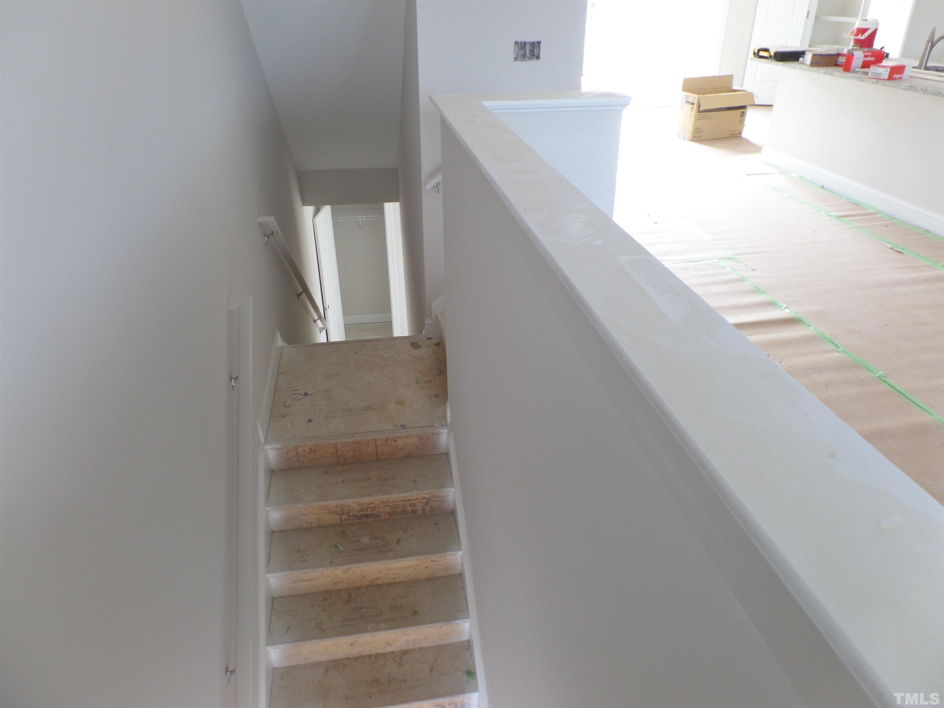 6912 Point Bar Place Raleigh, NC 27616 - Photo 9 of 26 a view of staircase and utility room with windows