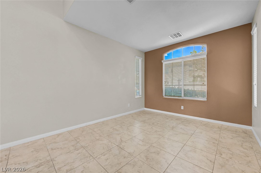 977 Sparkling Light Street Henderson, NV 89052 - Photo 20 of 75 This airy room offers ample space and abundant natural light, creating a serene and inviting atmosphere.