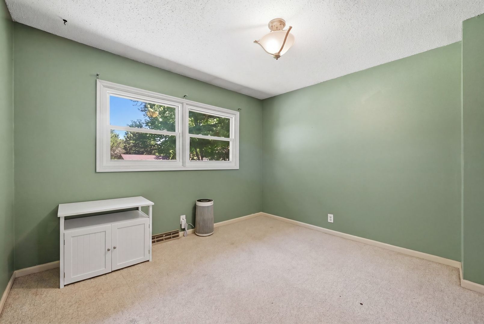 5645 Beebe Drive Rochelle, IL 61068 - Photo 10 of 43 a view of a bedroom with a window and a ceiling fan