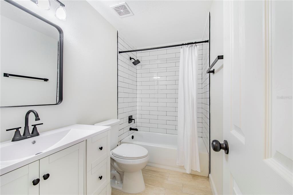 1221 Hartsell Avenue Lakeland, FL 33803 - Photo 11 of 17 a bathroom with a sink a toilet and shower