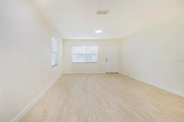 an empty room with a empty space and windows