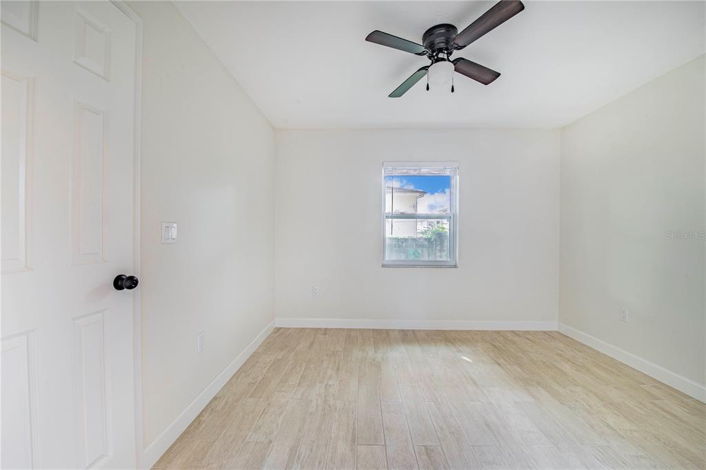 1221 Hartsell Avenue Lakeland, FL 33803 - Photo 9 of 17 an empty room with a window and a ceiling fan