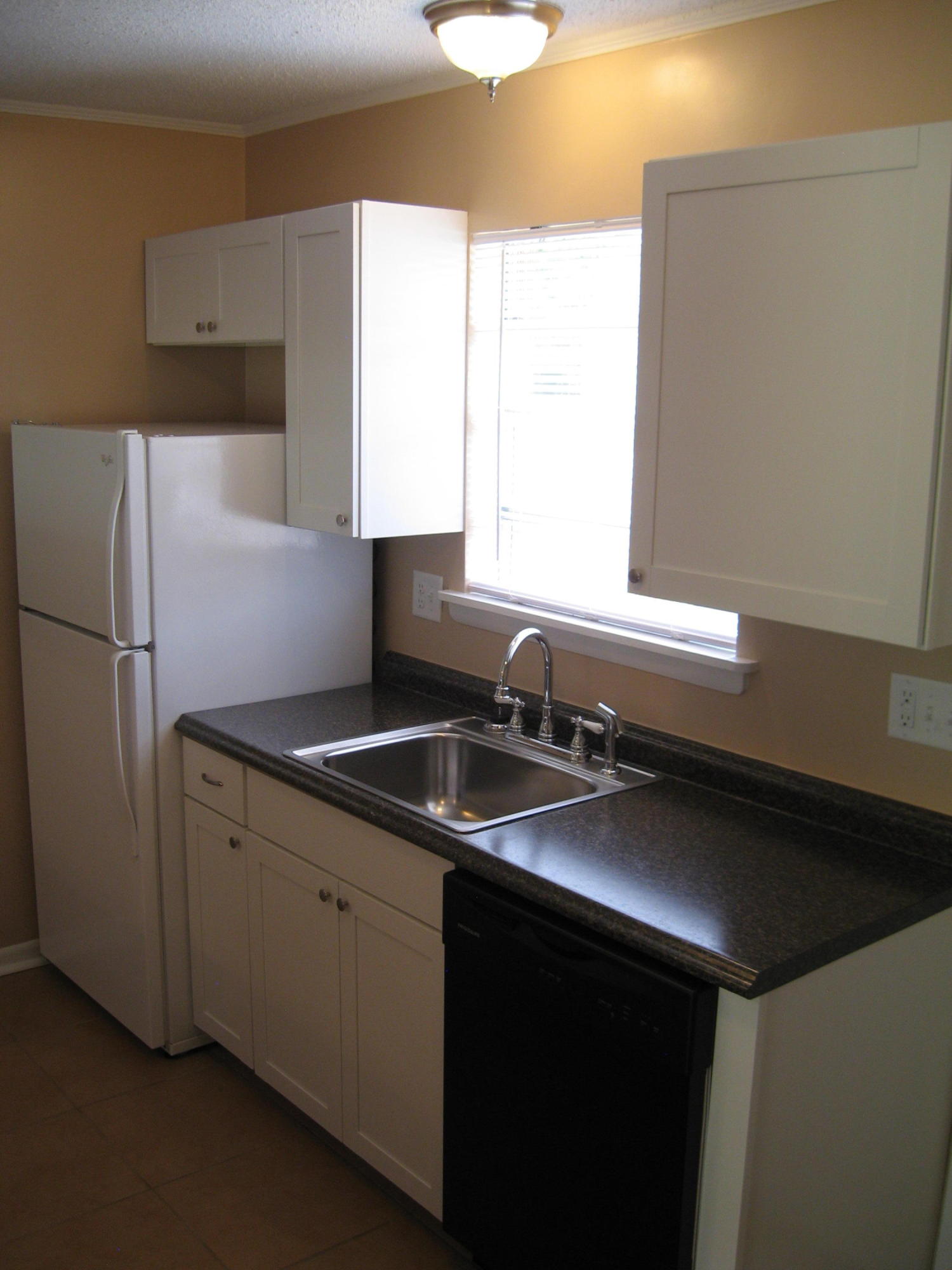 545 Hickory Avenue, Unit C Niceville, FL 32578 - Photo 4 of 11 a kitchen with a sink and a refrigerator