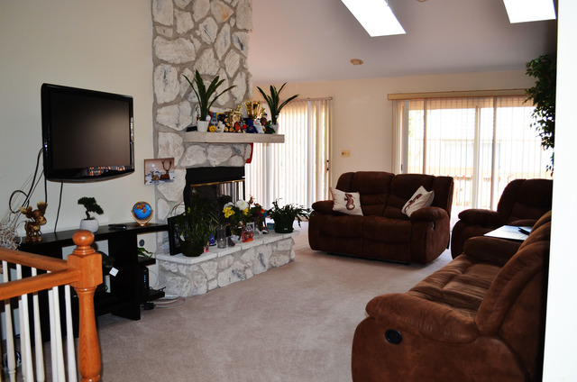 1829 Koehling Road Northbrook, IL 60062 - Photo 2 of 13 a living room with furniture a fireplace and a flat screen tv