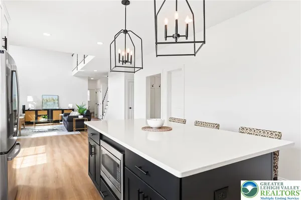 a open dining room with stainless steel appliances kitchen island a table chairs and a kitchen view