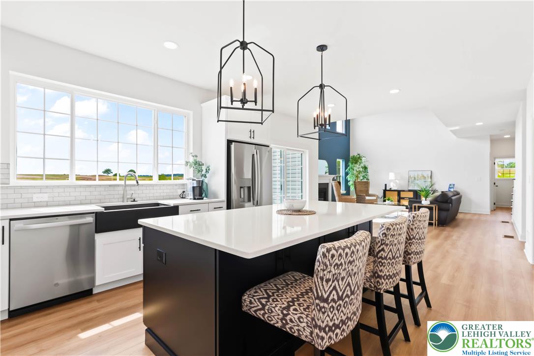 4450 Maple Street, Unit 2 Schnecksville, PA 18078 - Photo 12 of 45 a open dining room with stainless steel appliances kitchen island a table chairs and a kitchen view