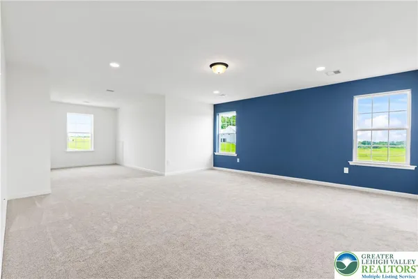 an empty room with windows and closet