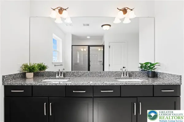 a spacious bathroom with a sink a mirror and a bathtub