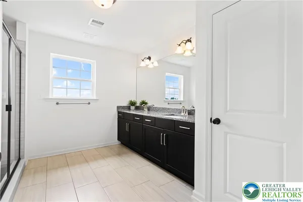 a bathroom with a glass shower door