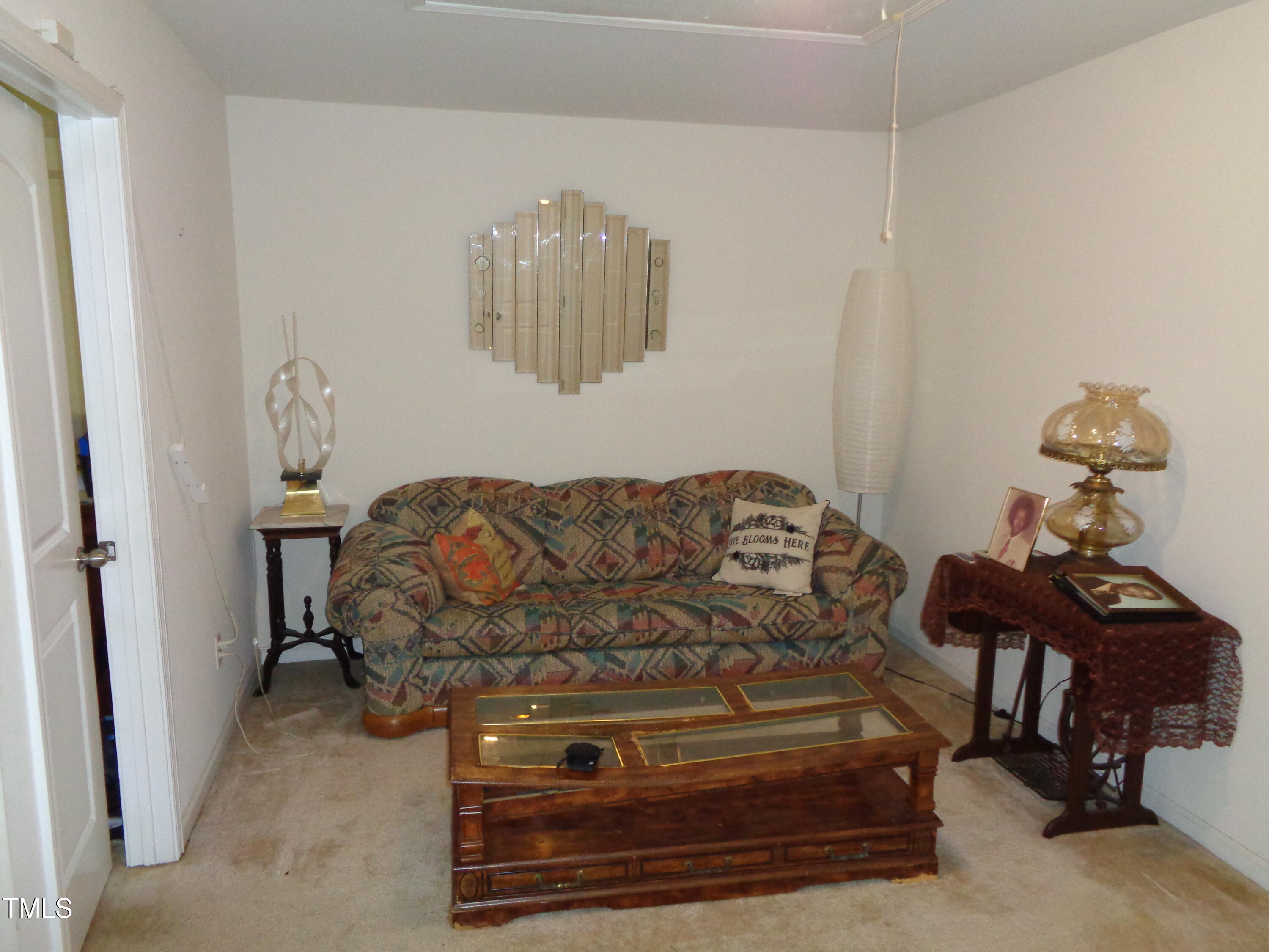 308 Switchback Street Knightdale, NC 27545 - Photo 11 of 17 a living room with furniture and a chandelier