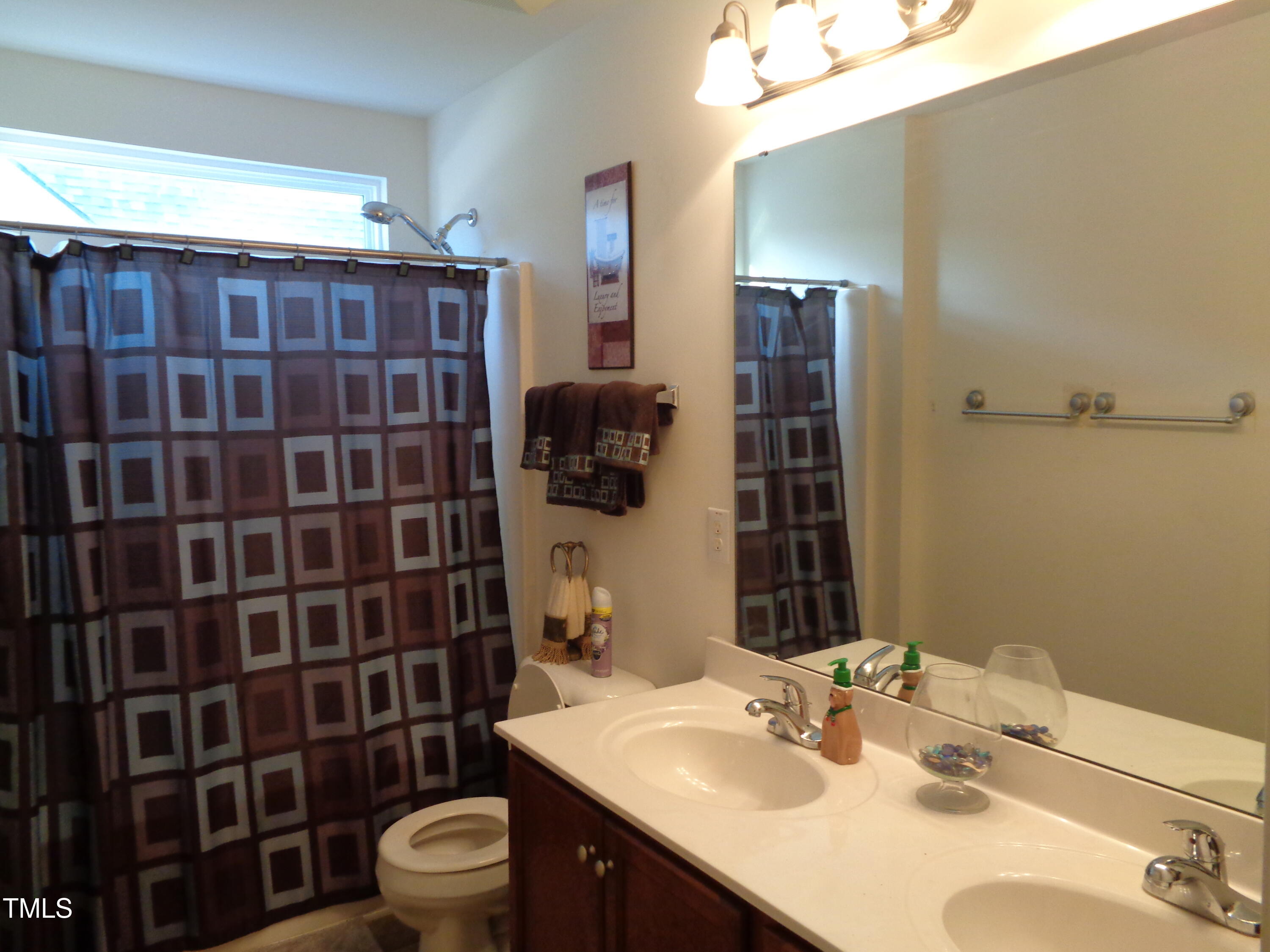 308 Switchback Street Knightdale, NC 27545 - Photo 12 of 17 a bathroom with a sink toilet and shower