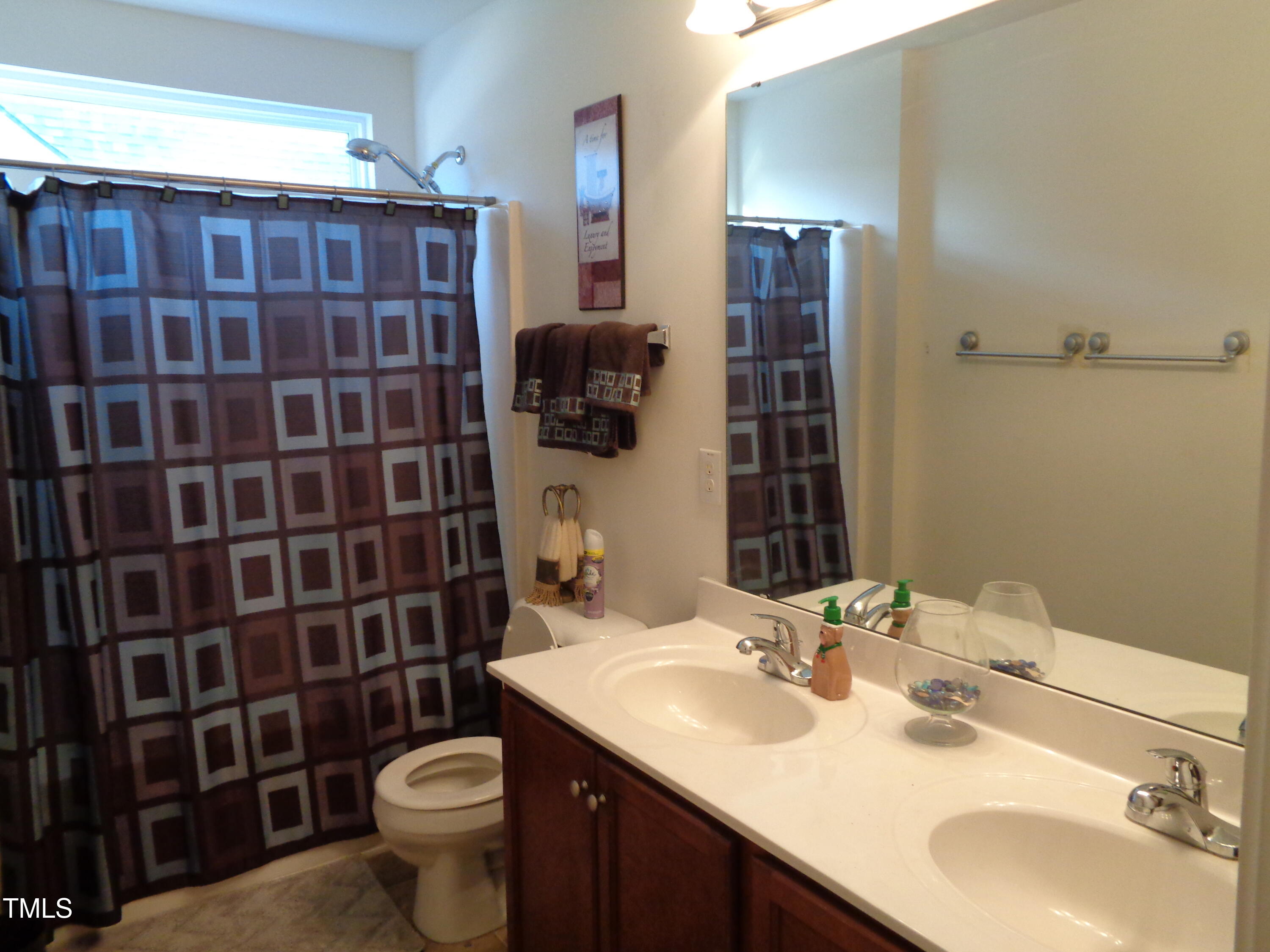 308 Switchback Street Knightdale, NC 27545 - Photo 13 of 17 a bathroom with a sink toilet and shower
