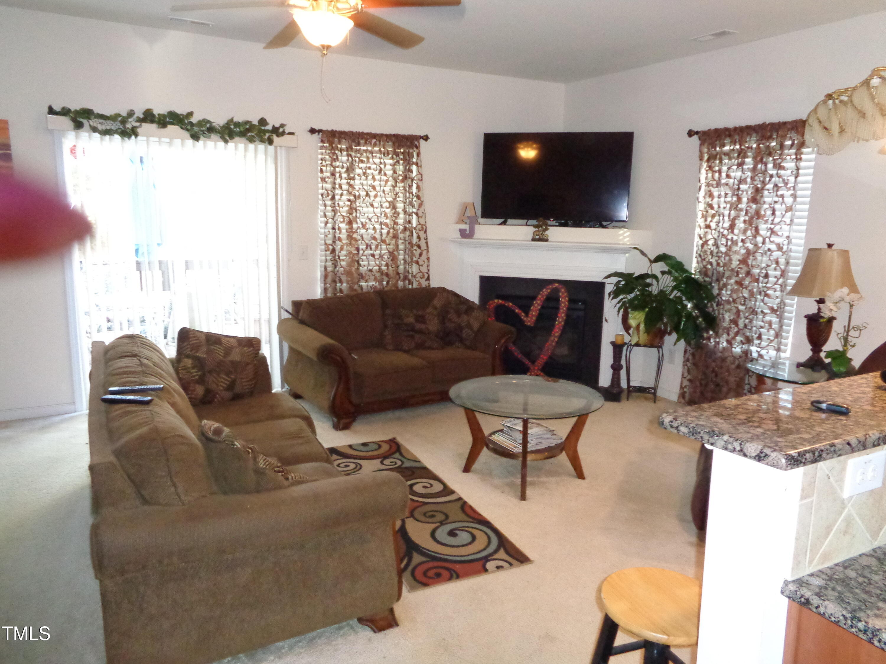 308 Switchback Street Knightdale, NC 27545 - Photo 2 of 17 a living room with furniture a flat screen tv and a large window