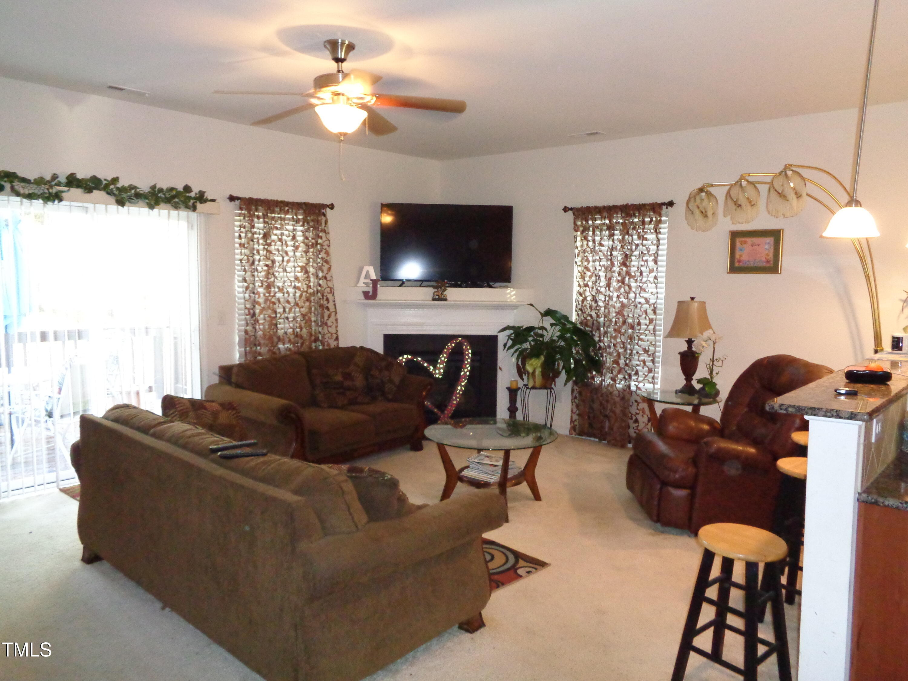 308 Switchback Street Knightdale, NC 27545 - Photo 3 of 17 a living room with furniture a flat screen tv and a window