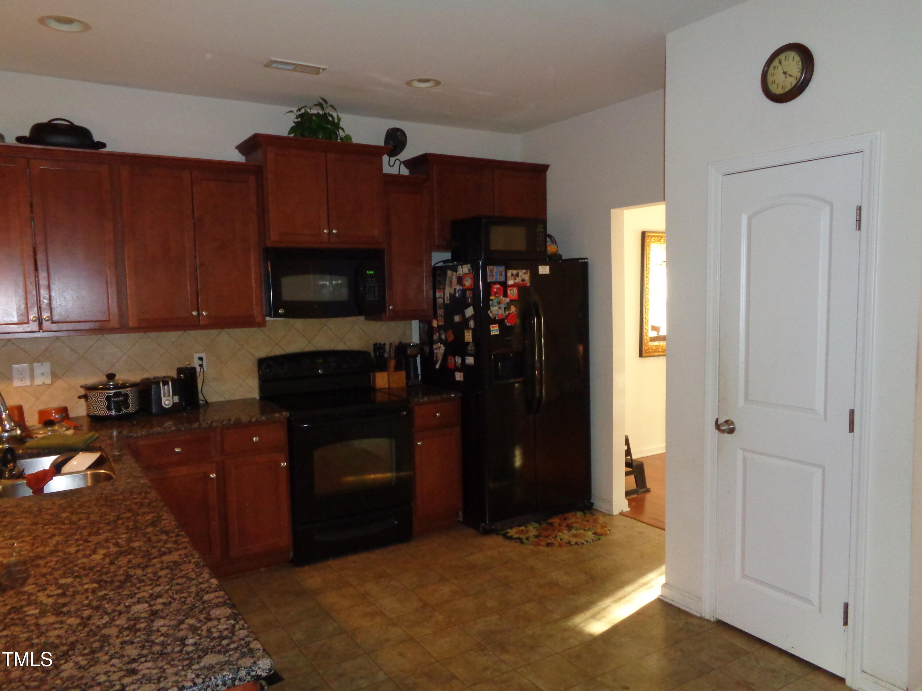 308 Switchback Street Knightdale, NC 27545 - Photo 5 of 17 a kitchen with a refrigerator and a stove