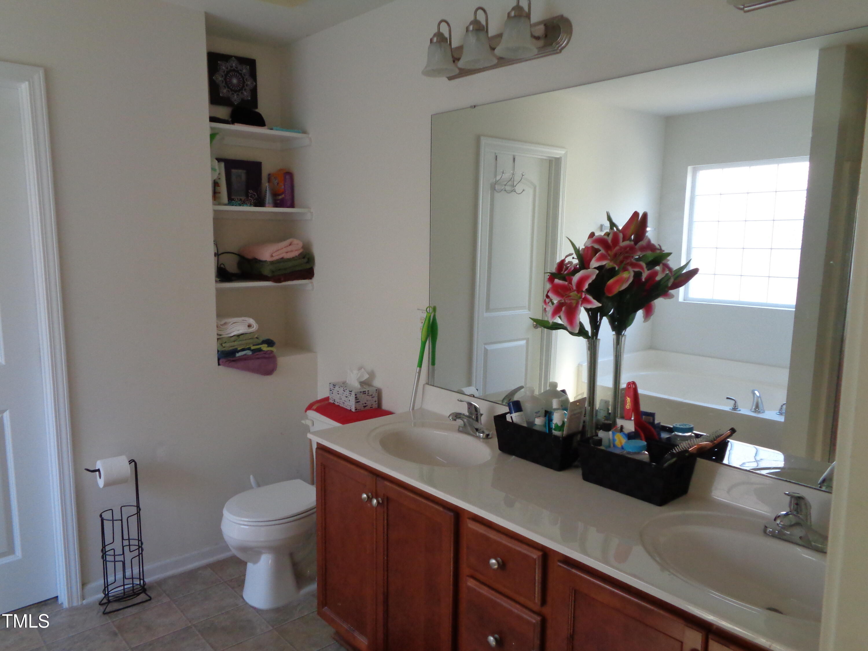 308 Switchback Street Knightdale, NC 27545 - Photo 8 of 17 a bathroom with a sink a vanity and a toilet
