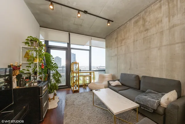 a living room with furniture and a floor to ceiling window