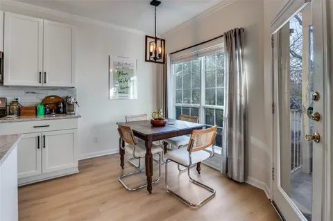 a kitchen with stainless steel appliances granite countertop a stove a sink and a refrigerator with wooden floor