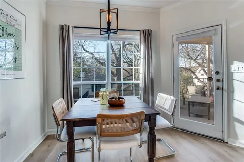 a dining room with furniture a chandelier and wooden floor