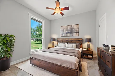 a bedroom with a large bed and a potted plant