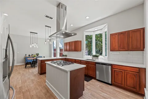 a kitchen with a sink stove and wooden cabinets