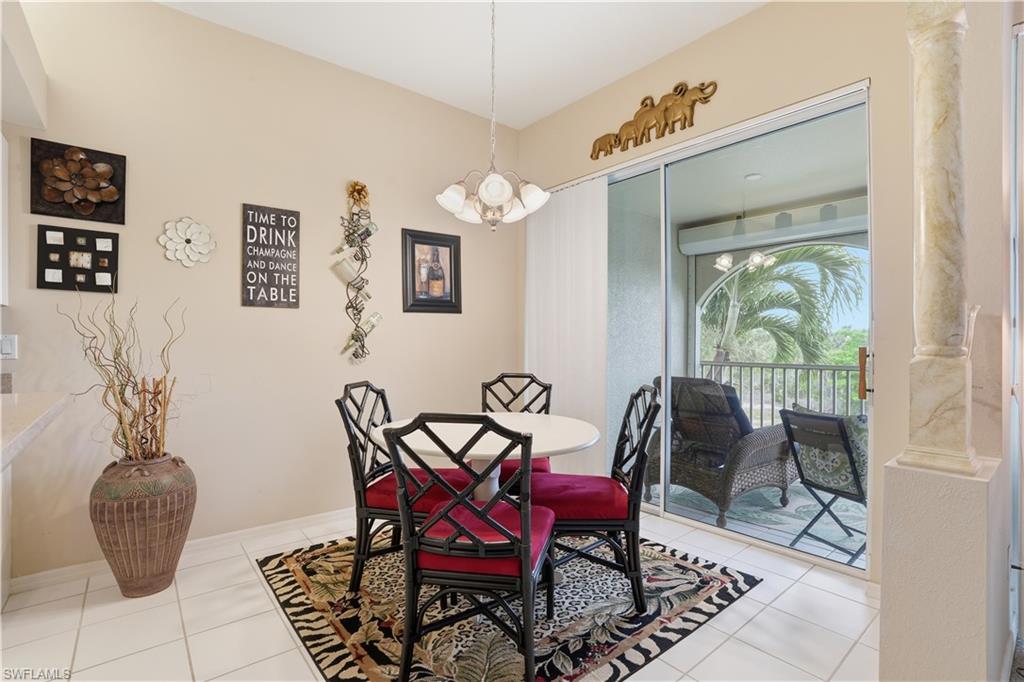 10871 Crooked River Road, Unit 202 Estero, FL 34135 - Photo 10 of 46 a dining room with furniture and window