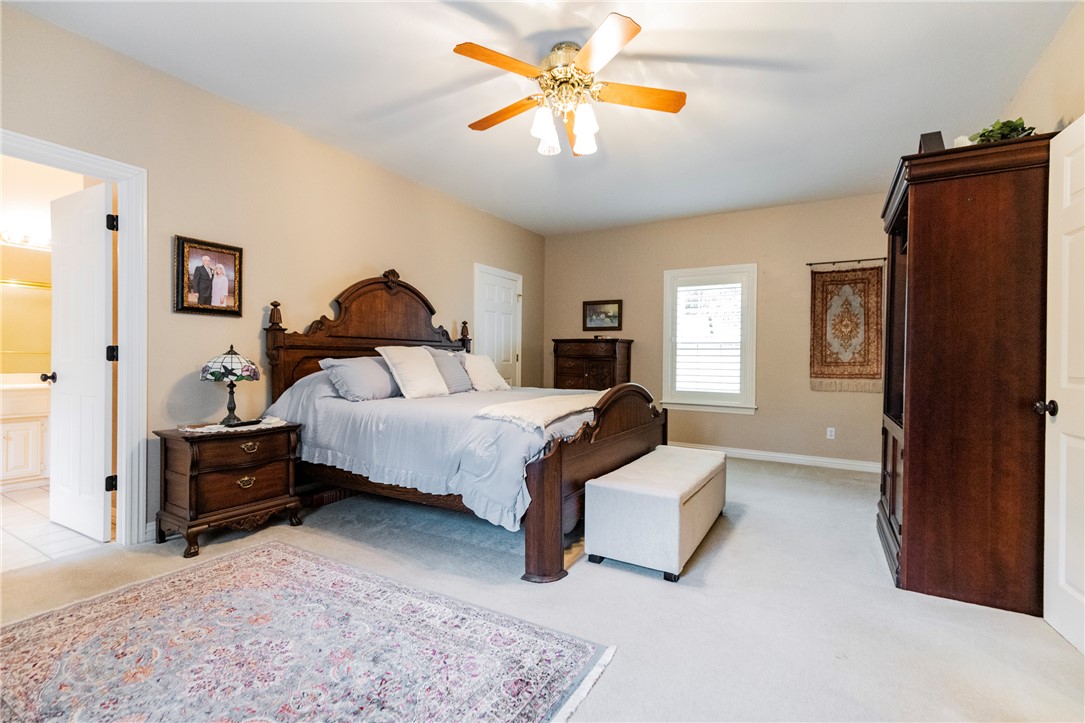 14203 Greenridge Road Fayetteville, AR 72701 - Photo 19 of 25 Spacious room featuring neutral wall tones, light-colored carpeting, a ceiling fan with integrated lighting, and a window with white louvered blinds