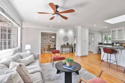 a living room with furniture a rug and a large window