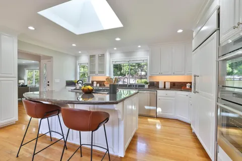 a kitchen with stainless steel appliances granite countertop counter space and a refrigerator