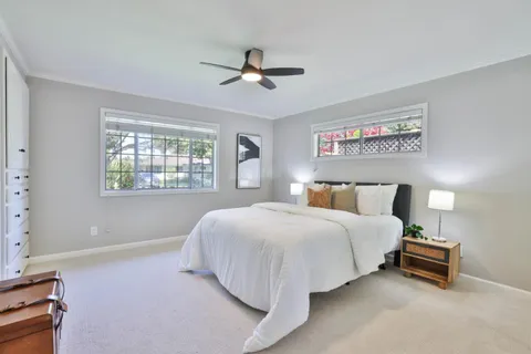 a bedroom with bed and a window