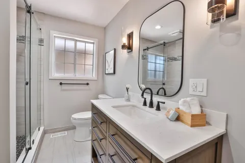 a bathroom with a sink toilet and shower