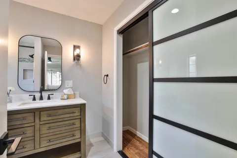 a spacious bedroom with a bed and glass window