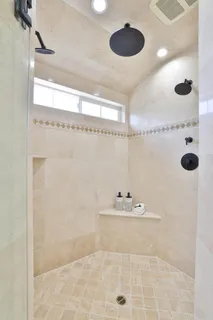 a spacious bathroom with a double vanity sink mirror and double