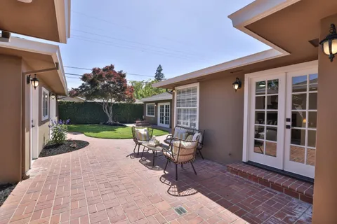 a view of house with backyard outdoor seating and green space