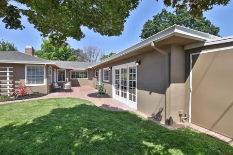 a view of a house with a yard porch and sitting area