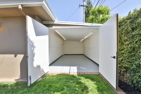 a view of a balcony with wooden floor and fence