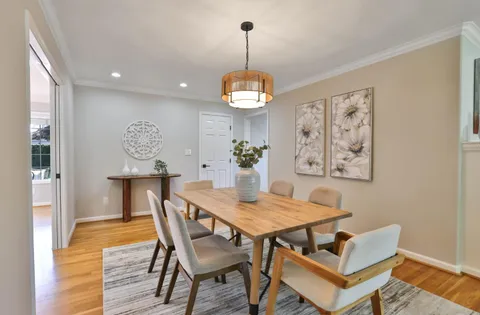 a dining room with furniture and window