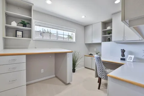 a kitchen with a sink cabinets and window