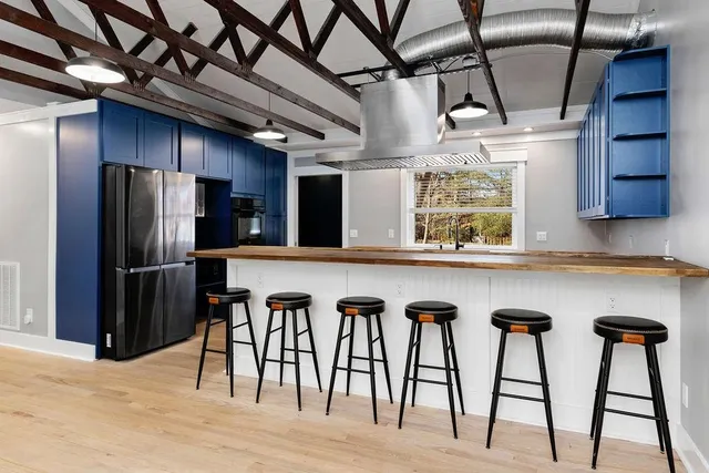 a kitchen with wooden cabinets and stainless steel appliances